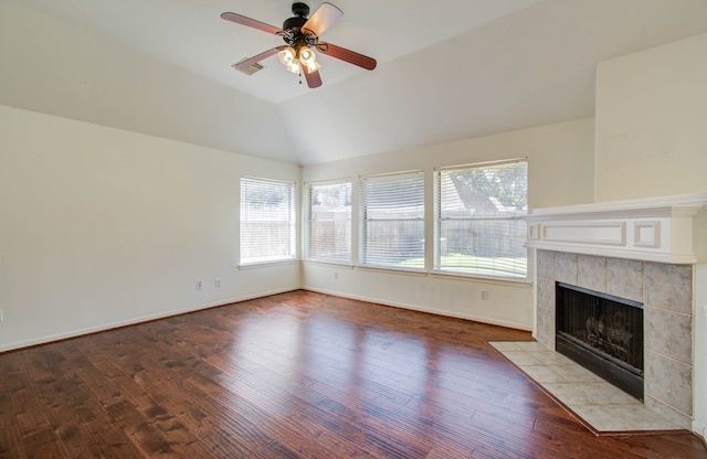 unfurnished living room featuring vaulted ceiling, hardwood / wood-style flooring, and plenty of natural light