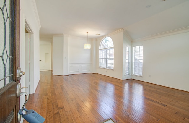 unfurnished room with crown molding and wood-type flooring