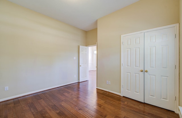 unfurnished bedroom featuring dark hardwood / wood-style floors and a closet