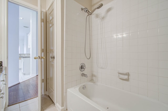 bathroom featuring tiled shower / bath and tile patterned floors