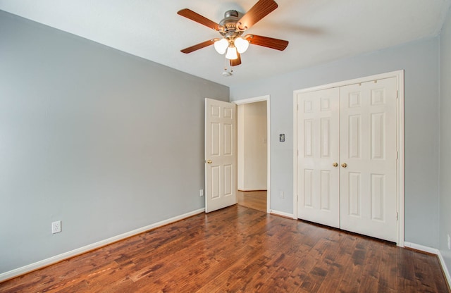 unfurnished bedroom featuring a closet, ceiling fan, and dark hardwood / wood-style flooring