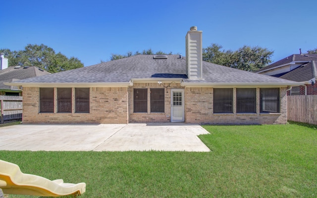 back of house featuring a patio area and a yard