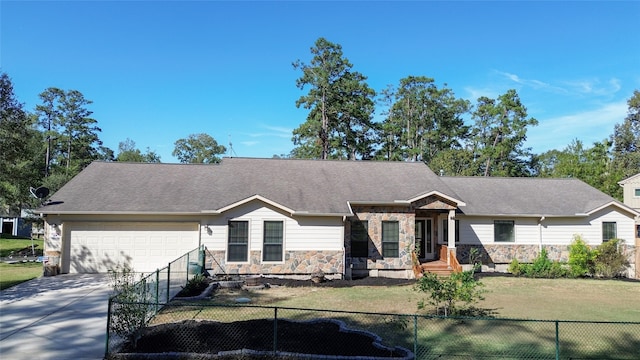 single story home featuring a garage and a front lawn