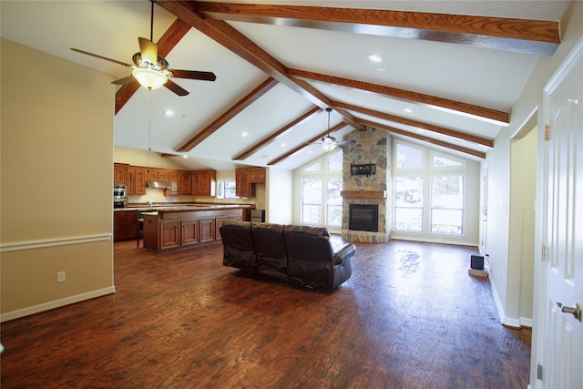 living room featuring ceiling fan, dark hardwood / wood-style flooring, a fireplace, and vaulted ceiling with beams