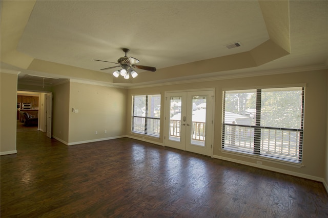 unfurnished room featuring dark wood-type flooring, french doors, crown molding, a tray ceiling, and ceiling fan