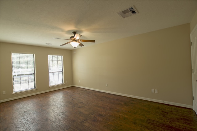 unfurnished room featuring dark hardwood / wood-style flooring and ceiling fan