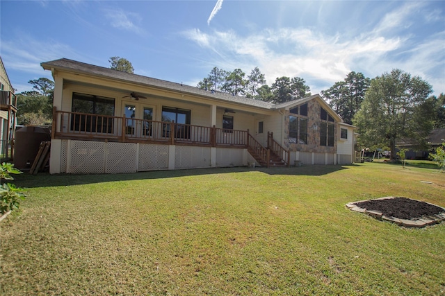 back of house featuring a yard and ceiling fan