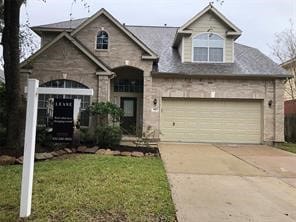 view of front of property featuring a garage and a front lawn