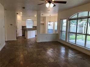 unfurnished living room featuring ceiling fan