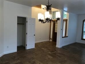 unfurnished dining area with a chandelier