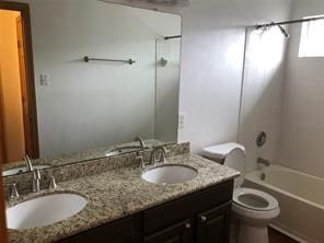 full bathroom featuring vanity, toilet, and shower / bathtub combination