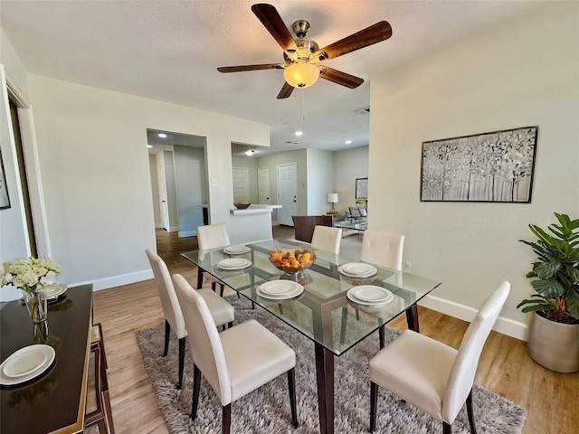 dining space featuring light hardwood / wood-style floors and ceiling fan