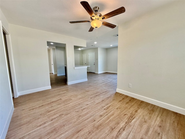 spare room featuring light hardwood / wood-style floors and ceiling fan