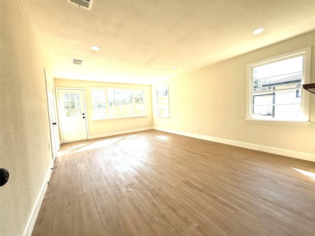 spare room with wood-type flooring