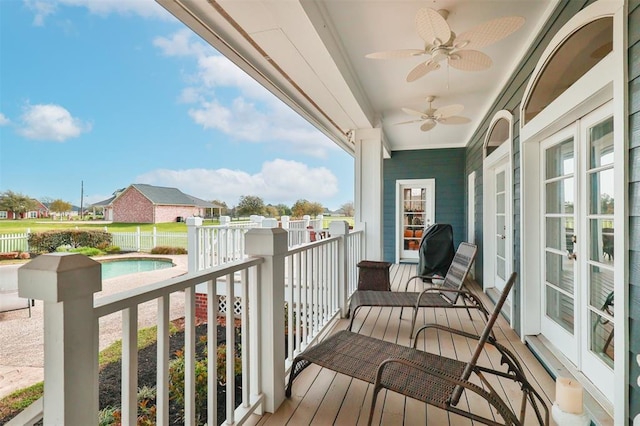 balcony with french doors and ceiling fan