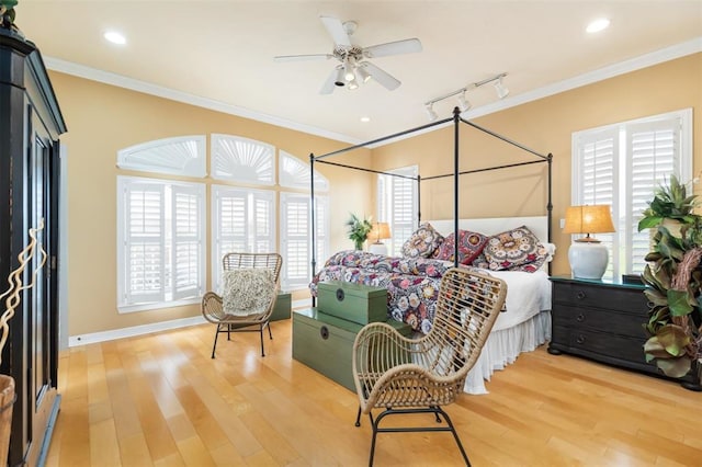 bedroom featuring ornamental molding, hardwood / wood-style flooring, and ceiling fan