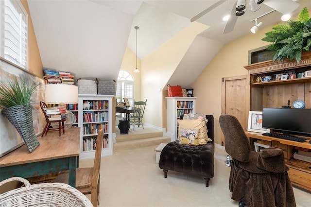 carpeted office with lofted ceiling and ceiling fan