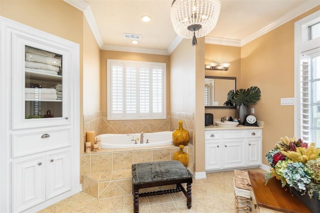 bathroom featuring vanity, a relaxing tiled tub, ornamental molding, and tile patterned floors