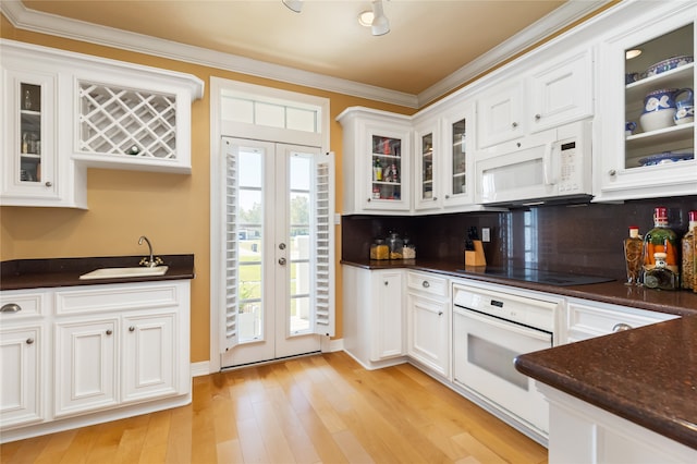 kitchen with decorative backsplash, light hardwood / wood-style flooring, crown molding, sink, and white appliances