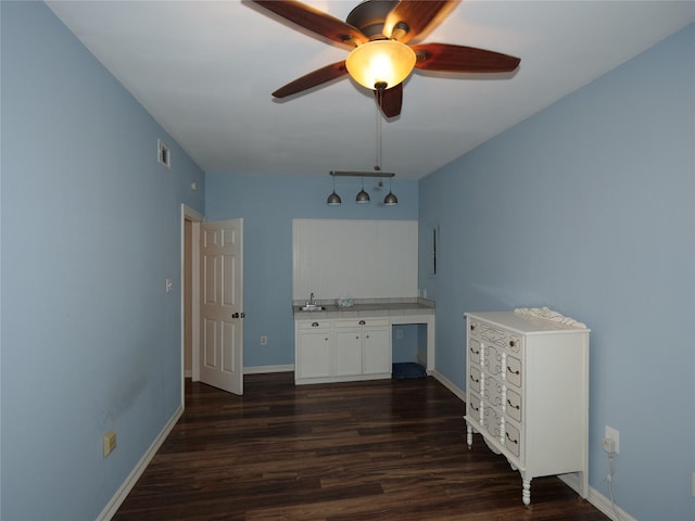 interior space with ceiling fan and dark wood-type flooring