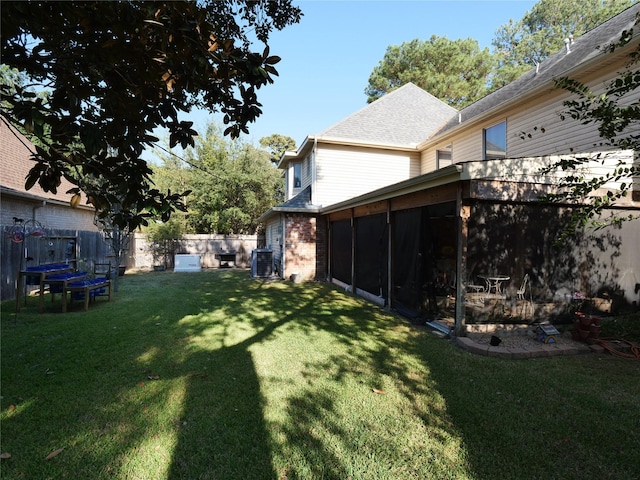 view of yard with central AC unit and a sunroom