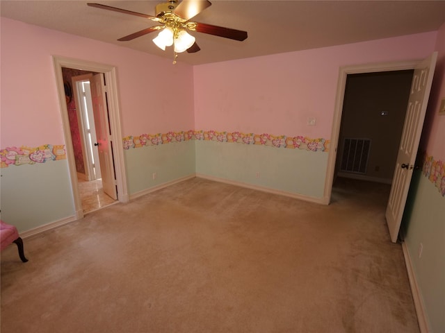 empty room featuring light carpet and ceiling fan