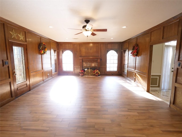 unfurnished living room featuring ceiling fan and wood-type flooring