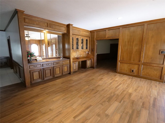 unfurnished living room with light hardwood / wood-style flooring and sink