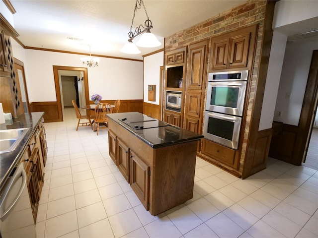 kitchen featuring a center island, hanging light fixtures, stainless steel appliances, brick wall, and crown molding