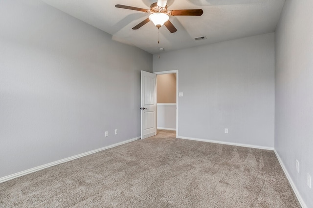 carpeted spare room with ceiling fan