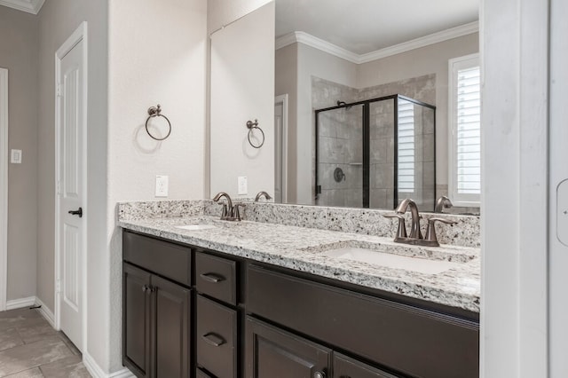 bathroom with vanity, crown molding, and a shower with shower door