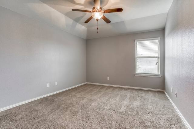 unfurnished room with lofted ceiling, carpet floors, and ceiling fan