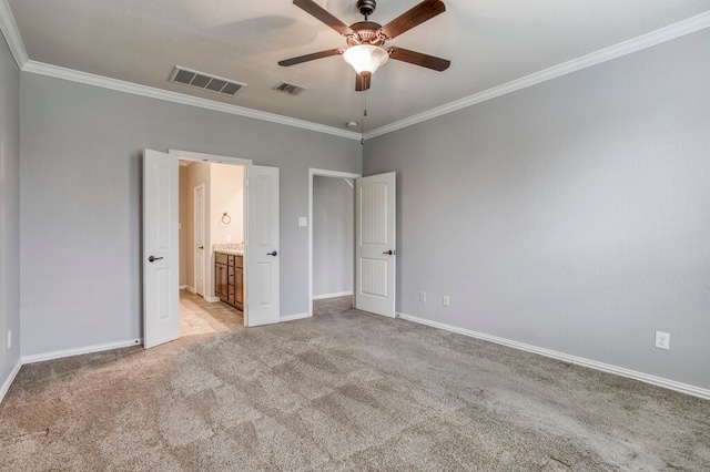 unfurnished bedroom with crown molding, light colored carpet, and ceiling fan