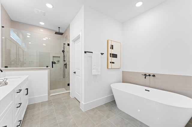 bathroom with shower with separate bathtub, vanity, and tile patterned floors