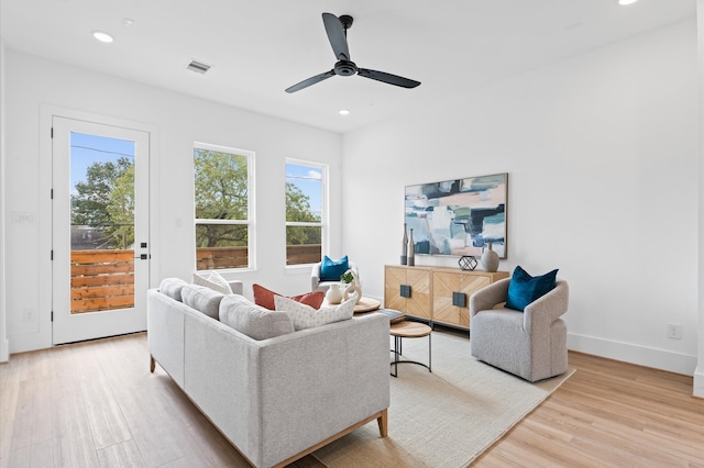 living room featuring light wood-type flooring and ceiling fan