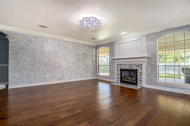 unfurnished living room featuring crown molding, a stone fireplace, and dark hardwood / wood-style floors