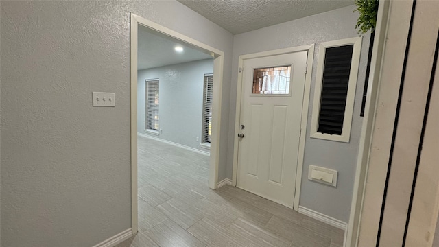 entrance foyer with a textured ceiling