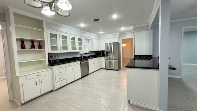 kitchen featuring stainless steel appliances, ornamental molding, sink, and white cabinets