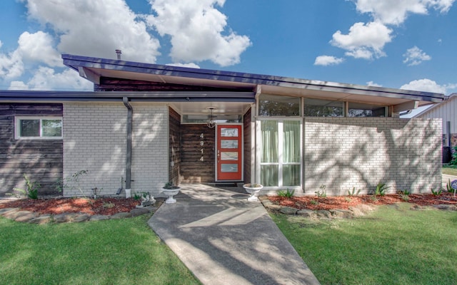 doorway to property with a yard