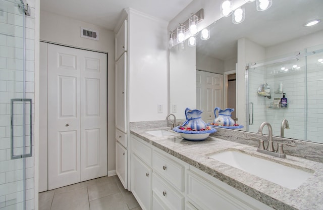 bathroom with vanity, walk in shower, and tile patterned flooring