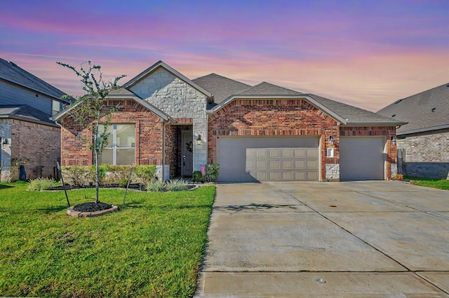 front of property with a garage and a yard