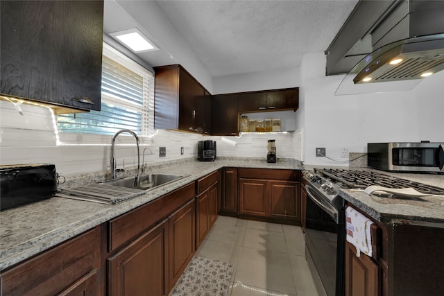 kitchen featuring light tile patterned floors, appliances with stainless steel finishes, sink, light stone counters, and exhaust hood