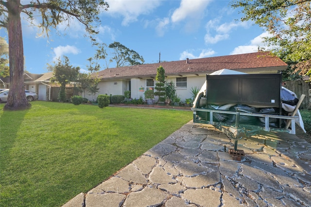 back of house with a yard and a garage