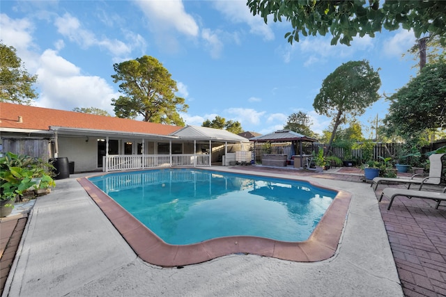 view of swimming pool with a gazebo and a patio area