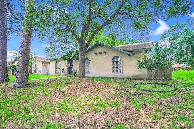 ranch-style house with a front lawn