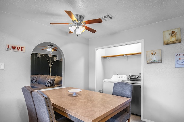 dining space with washer and clothes dryer, a textured ceiling, light tile patterned floors, and ceiling fan