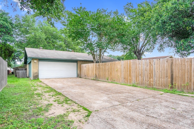 garage featuring a lawn