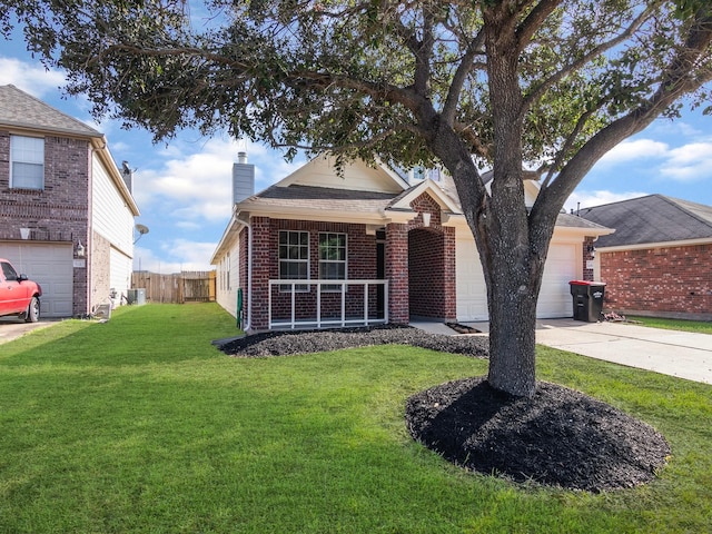 view of front of property with covered porch, a garage, and a front yard