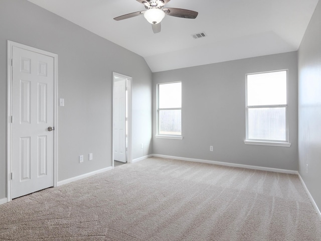 unfurnished bedroom featuring light carpet, ceiling fan, and lofted ceiling