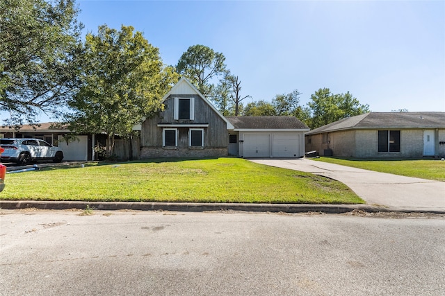 view of front of property featuring a front yard and a garage